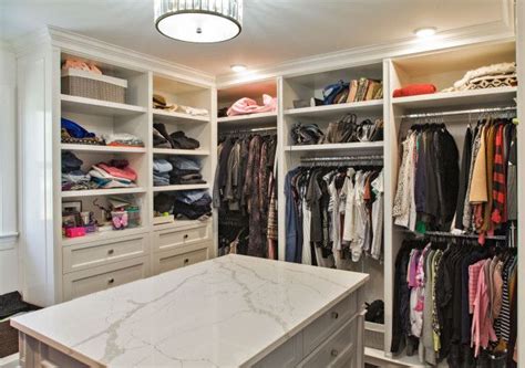 A Walk In Closet With Marble Counter Top