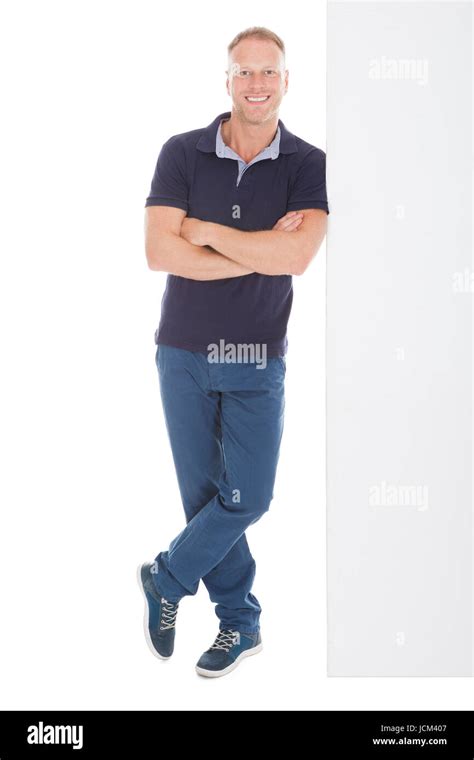 Full Length Portrait Of Smiling Mid Adult Man Standing Arms Crossed