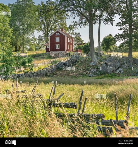 Small Country Road And Old Traditional Red Cottages In A Rural