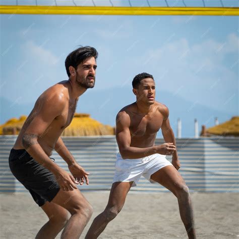 Premium Photo Young Men Playing Beach Volleyball On The Beach On A