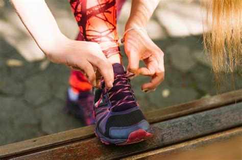 Free Photo Crop Woman Tying Laces On Sneakers