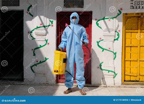 Indian Sanitary Worker In A Protective Suit Conducting Disinfection Of