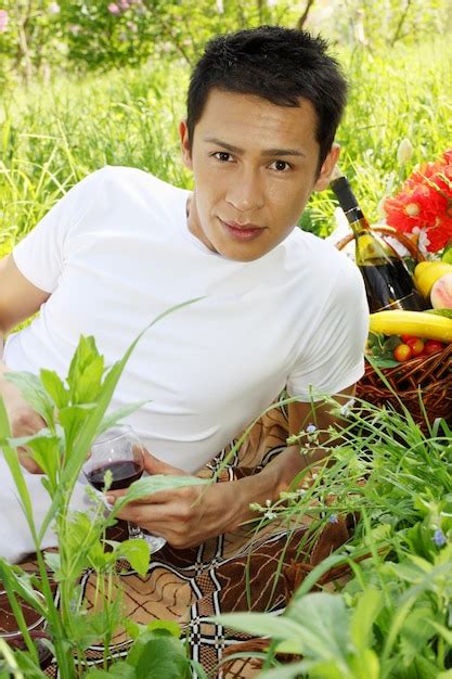 Premium Photo A Handsome Man Holding A Glass Of Wine