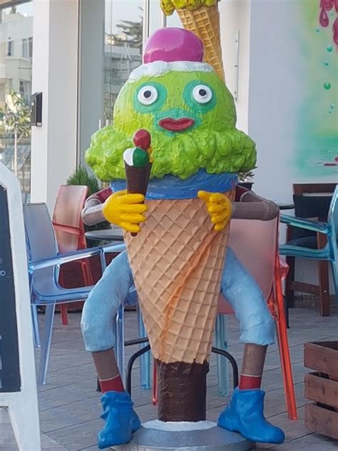 An unsettling ice cream cone with face : oddlyterrifying