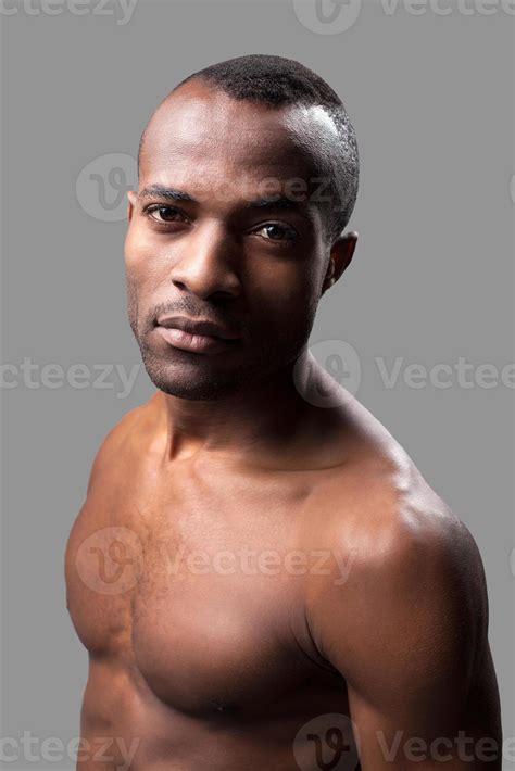 Manly And Muscular Shirtless African Man Looking At Camera While