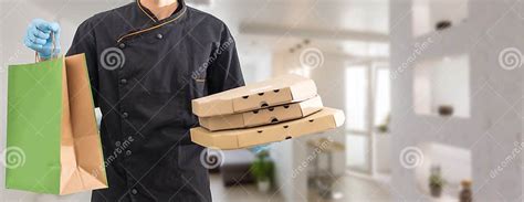 Box With Fast Food Being Carried By Delivery Man In Uniform For One Of