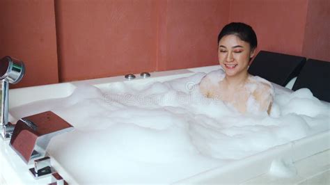 Woman Relaxing And Takes Bubble Bath In Bathtub With Foam Stock Video