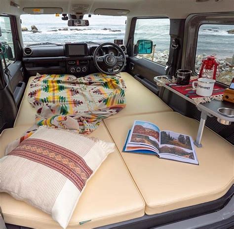 the interior of a camper with an open bed and magazine on it's side