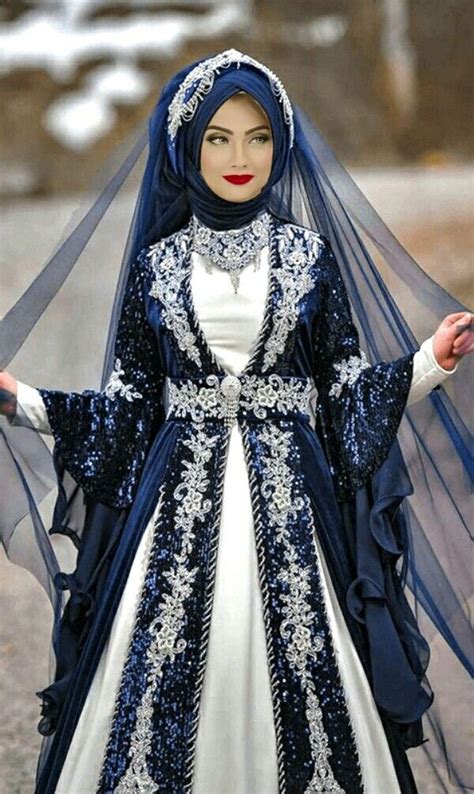 A Woman In A Blue And White Wedding Dress With Veil On Her Head