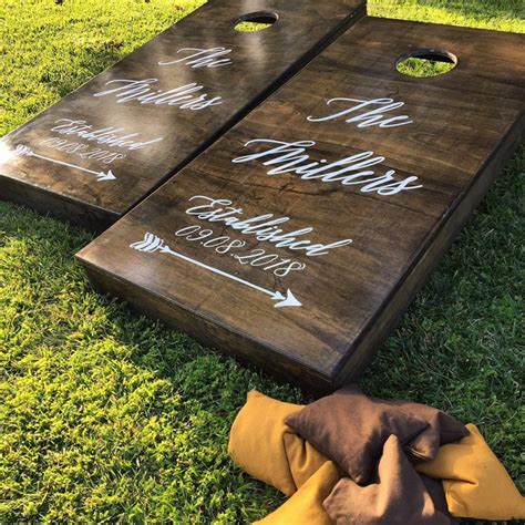 Two Cornhole Game Boards On The Grass