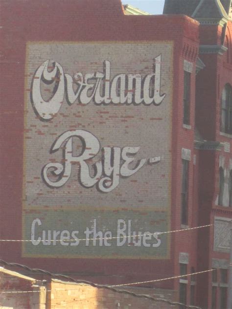 An Old Sign On The Side Of A Building Advertising Rye S In New York City