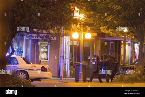 A Nebraska State Patrol Swat Team Backs Away From The Front Of Thiele