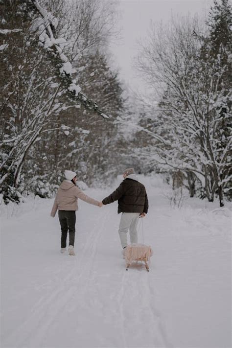 Couple Walking with a Dog in a Forest in Winter · Free Stock Photo