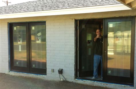 Replacing windows with Anderson Doors.