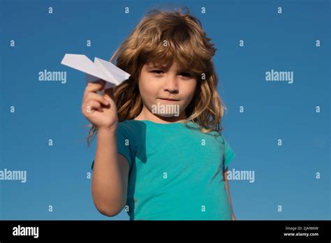 Paper Airplane In Children Hands Child Throwing A Paper Airplane Into