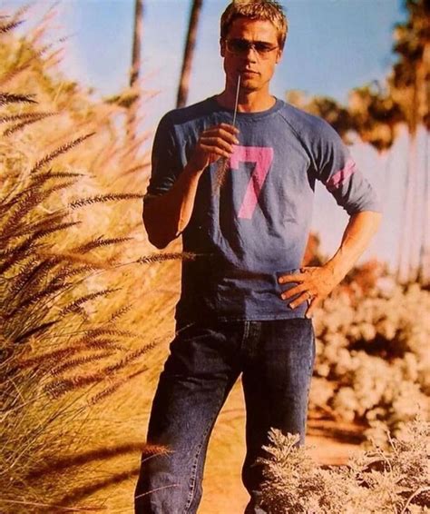 A Man Standing In The Middle Of Some Tall Grass