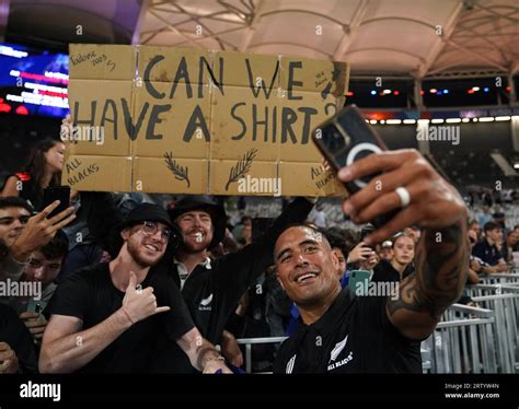 New Zealand's Aaron Smith poses for a a selfie with fans following ...