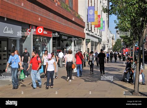 Shoppers Walking Along Wide Oxford Street Pavement With Marks And