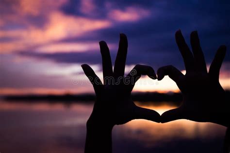 Silhouette of Hands with Heart Shape with Beautiful Color Sunset Stock ...