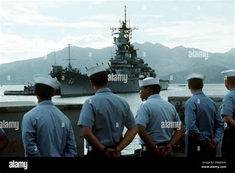 Crew Members From Another Us Navy Ship Watch As The Large Harbor Tugs