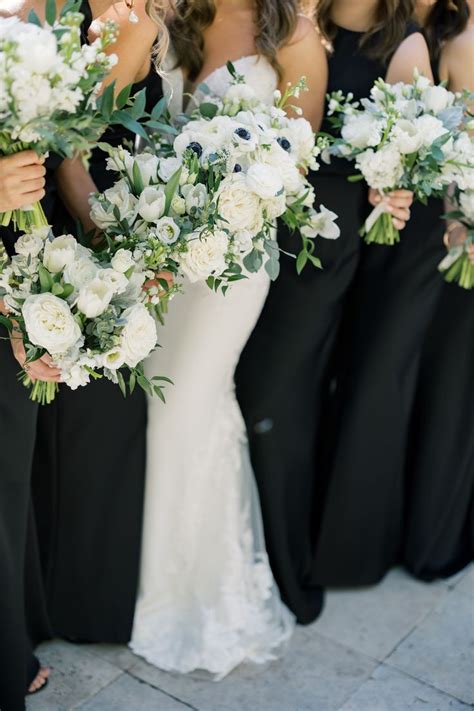 The Bridesmaids Are Holding Their Bouquets With White And Green Flowers