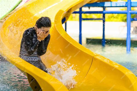 Premium Photo Young Asian Female Going Down A Water Slide