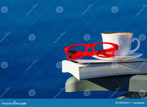 Coffee Cup Book And Glasses Against Blue Sea Stock Image Image Of Glasses Empower 289940971