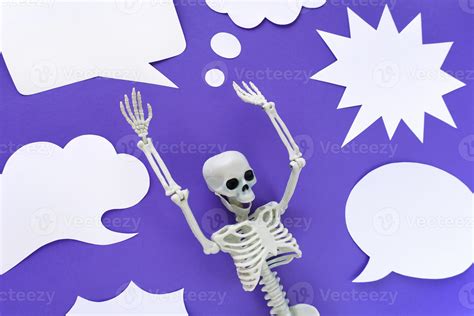 Skeleton On Violet Background With Lots Of White Blank Paper Speech