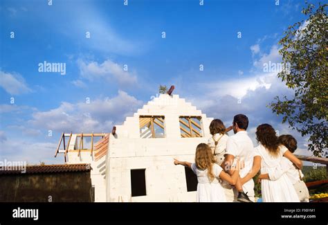 Happy and big family builds a new house for living Stock Photo - Alamy