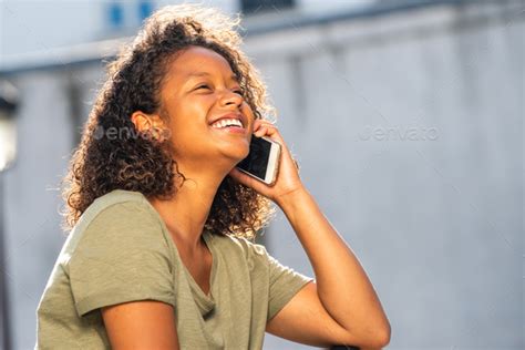 Close Up Side Of Young African American Woman Laughing While Talking