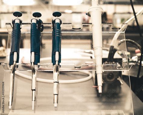 A set of various replicating pipettes in a research laboratory sitting ...