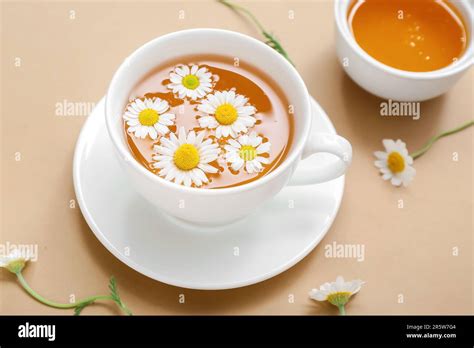 Cup Of Hot Chamomile Tea With Honey On Beige Background Stock Photo Alamy