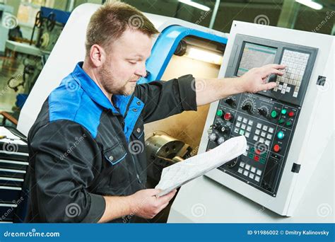 Industrial Worker Operating Cnc Turning Machine In Metal Machining