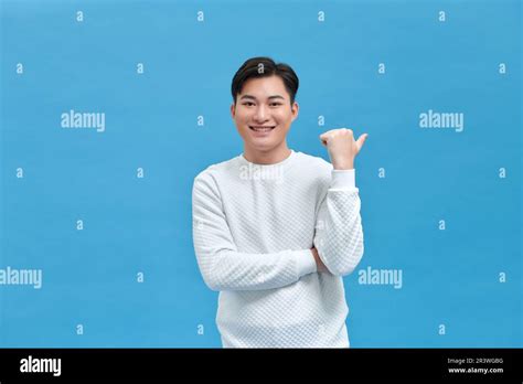 young handsome man pointing      hand  thumbs