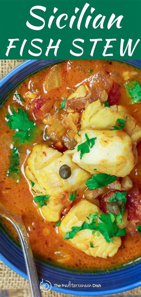 A Blue Bowl Filled With Fish Stew And Garnished With Parsley