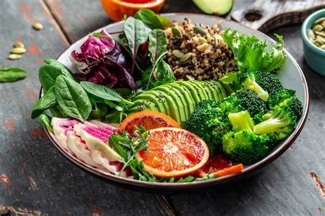 Premium Photo | Healthy vegetarian buddha bowl salad with fruit, vegetable and seeds. Close up.