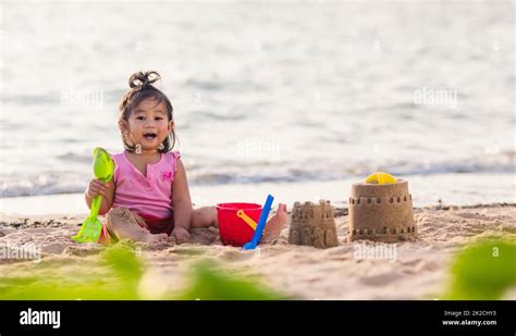 cute little girl playing sand with toy sand tools Stock Photo - Alamy