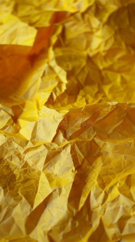 Crumpled Yellow Paper Texture In Close Up View Abstract Background