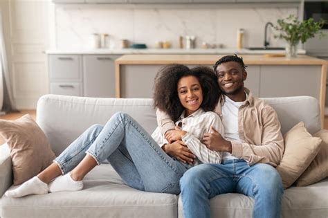 Premium Photo Romantic African Couple Hugging While Chilling On Couch