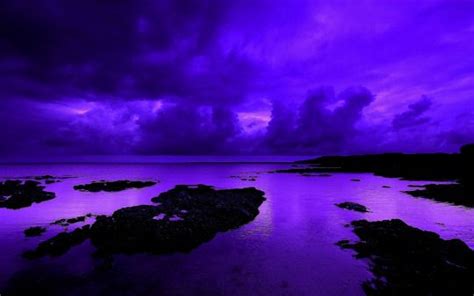 Purple Sky Over The Ocean With Rocks And Water