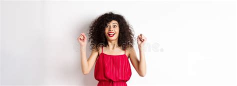 Excited Curly Haired Woman With Evening Makeup Gasping Fascinated