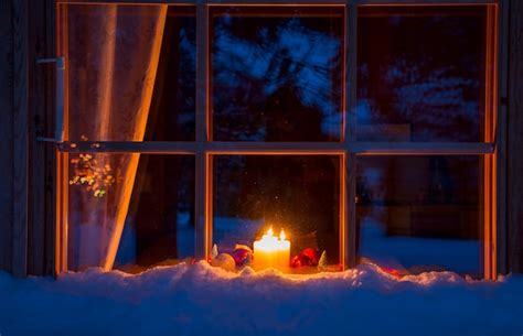 Premium Photo | Snowy evening window of a wooden house. on the ...