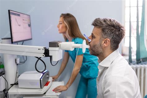 Premium Photo | Man performing pulmonary function test and spirometry using spirometer at ...