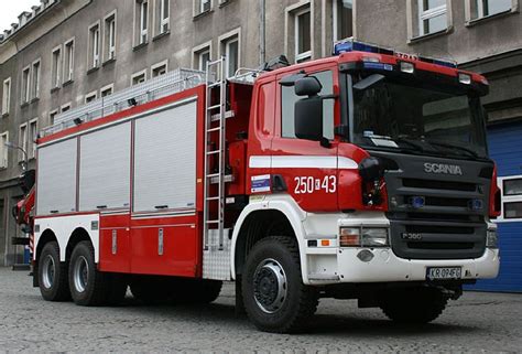 A Red And White Fire Truck Parked In Front Of A Building