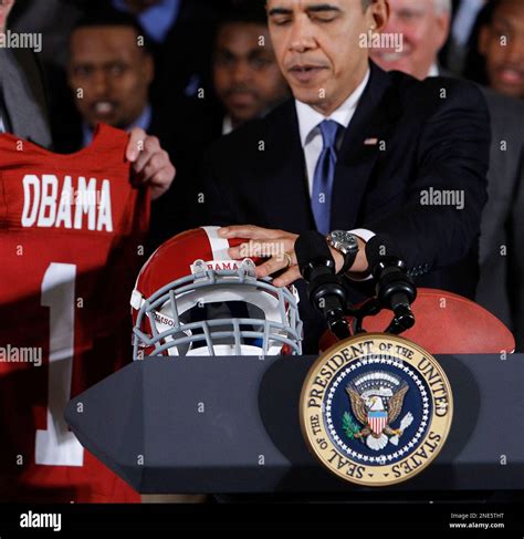 President Barack Obama Places A University Of Alabama Football Helmet