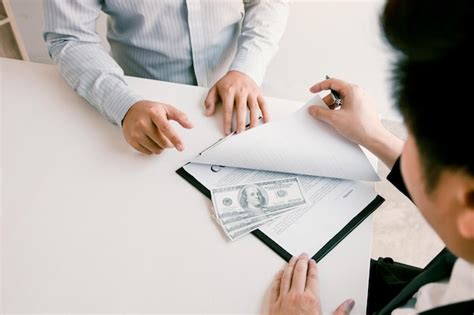 Premium Photo Midsection Of Businessman Bribing Coworker In Office