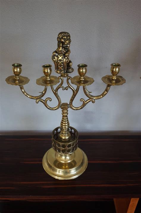 Large Pair Of Brass Candelabras With Lions Holding The Coat Of Arms Of