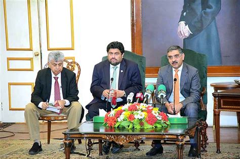 Flanked By Governor Sindh And Federal Minister For Information