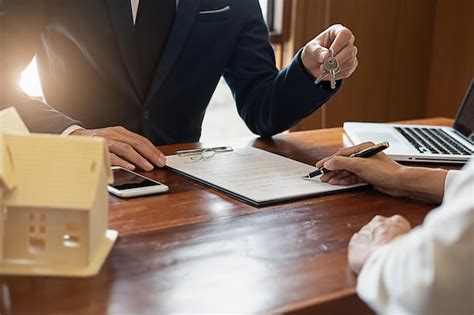 Premium Photo Close Up Of Estate Agent Giving Key While Client