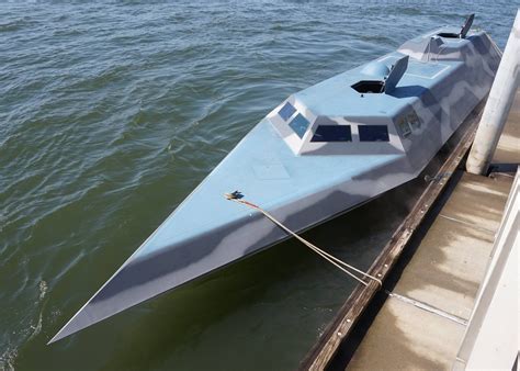 A Blue Boat Sitting On Top Of A Pier Next To The Ocean With Water In